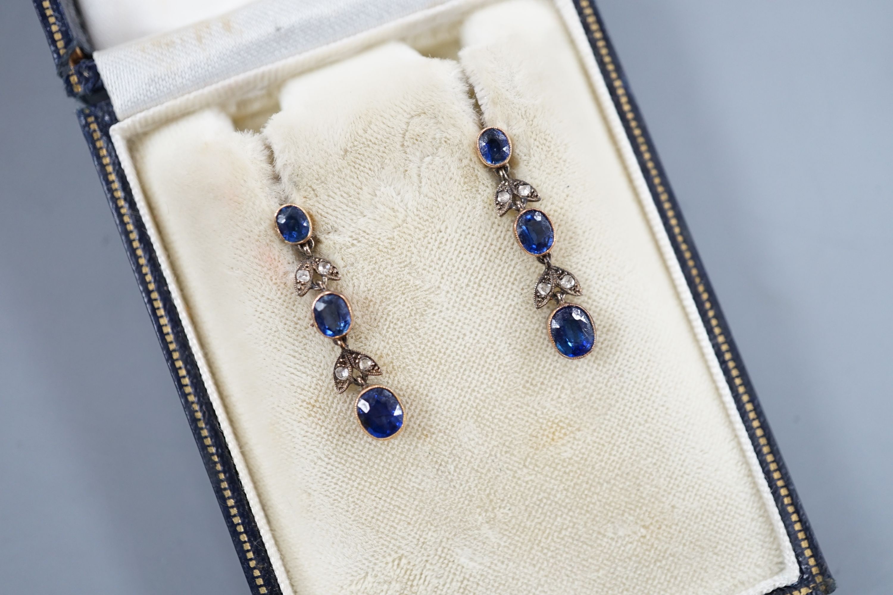 A pair of late Victorian 9ct, three stone sapphire and four stone rose cut diamond set drop earrings, 25mm, gross 3.1 grams.